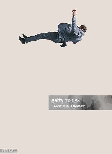 businessman in suit falling down from high up - person falling mid air stock pictures, royalty-free photos & images