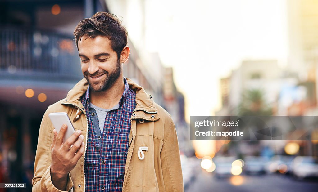 Checking his texts while in the city