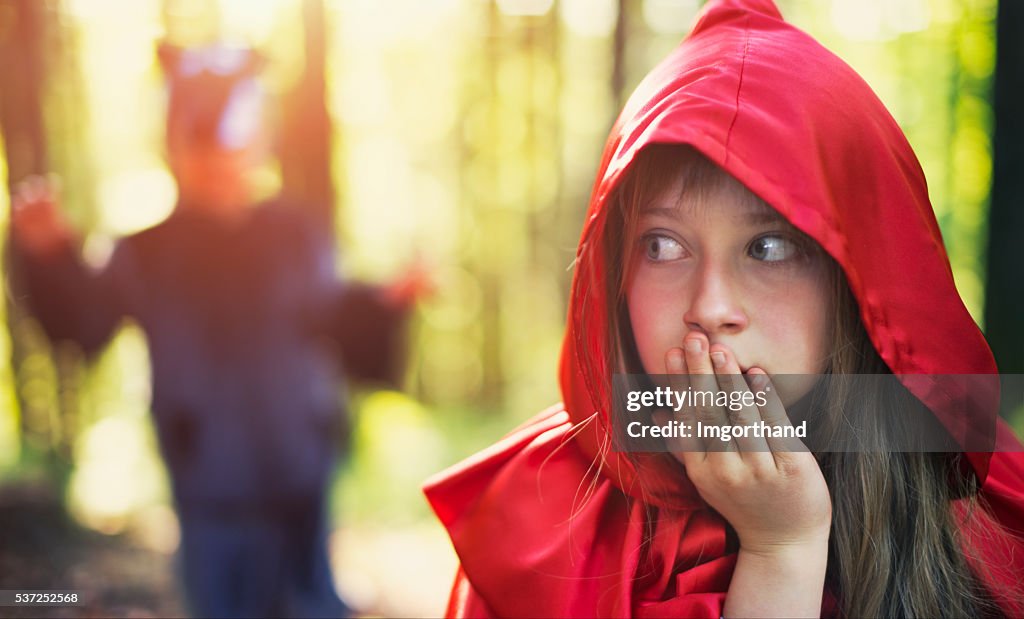 Little Red Riding Hood noticing the wolf
