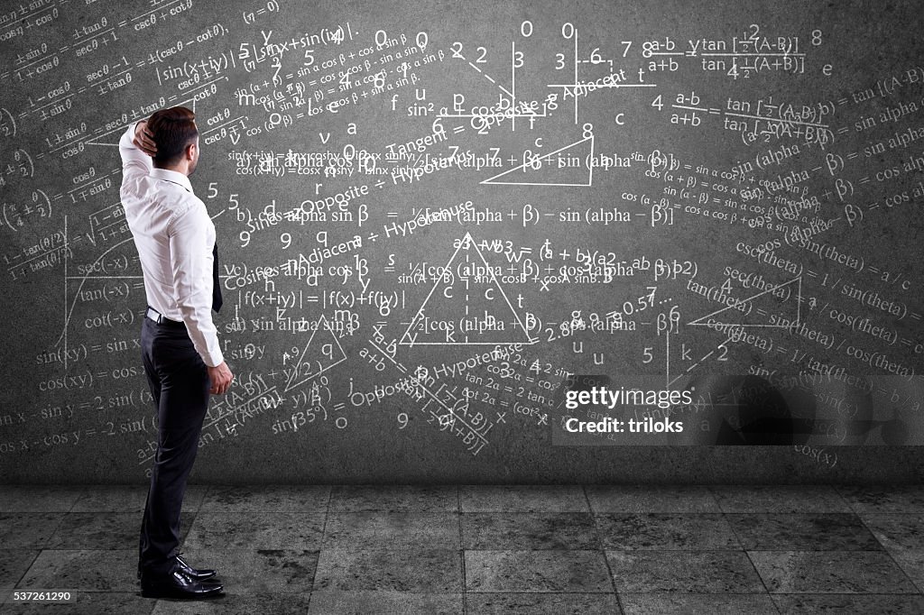 Businessman solving mathematical equation
