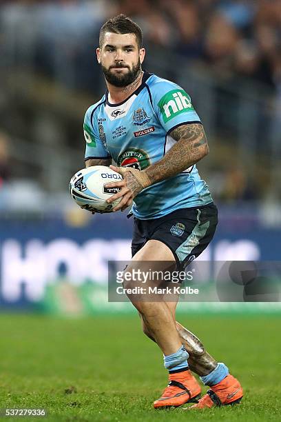 Adam Reynolds of the Blues runs the ball during game one of the State Of Origin series between the New South Wales Blues and the Queensland Maroons...