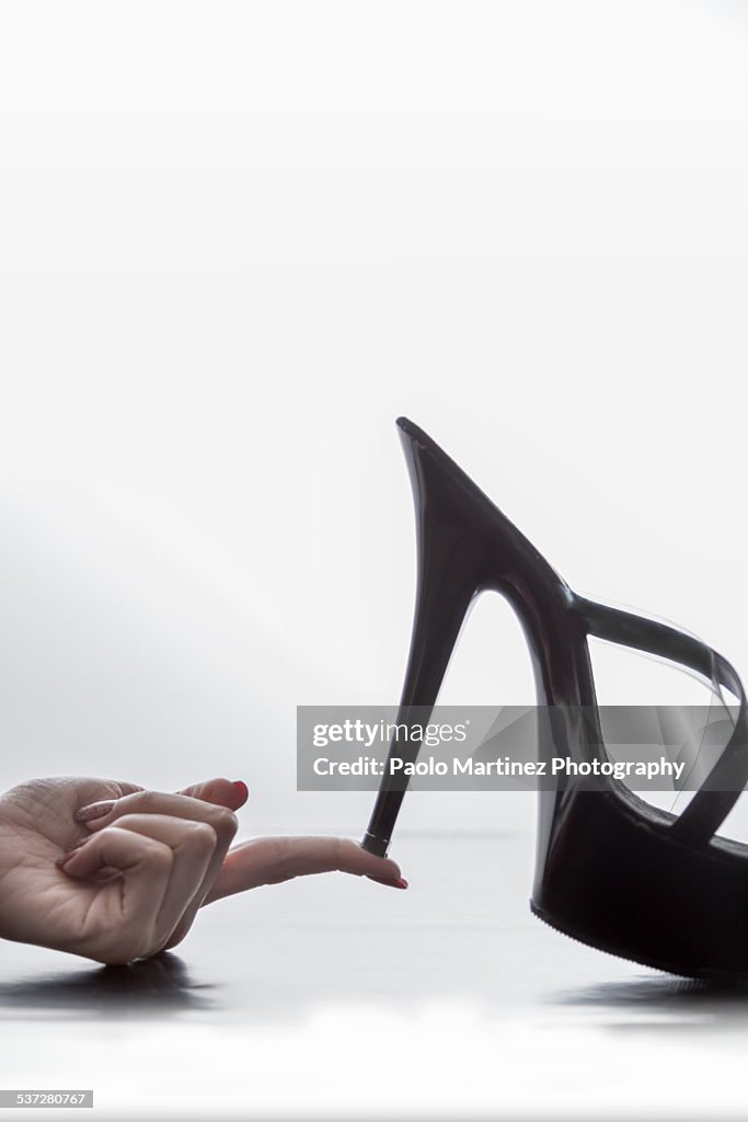 Holding a stiletto sandal