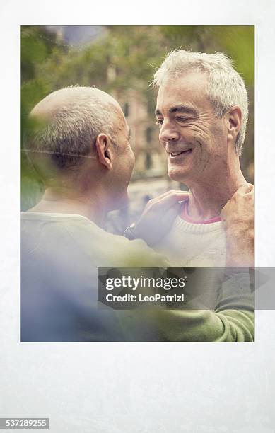 homosexual couple in love at the park - gay men pic stock pictures, royalty-free photos & images