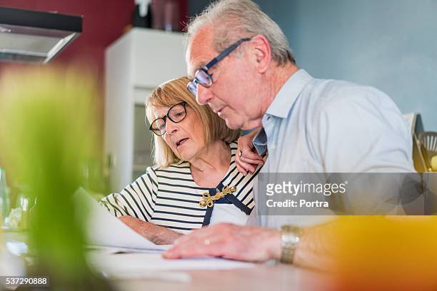 senior couple calculating home finance - house inspection stock pictures, royalty-free photos & images