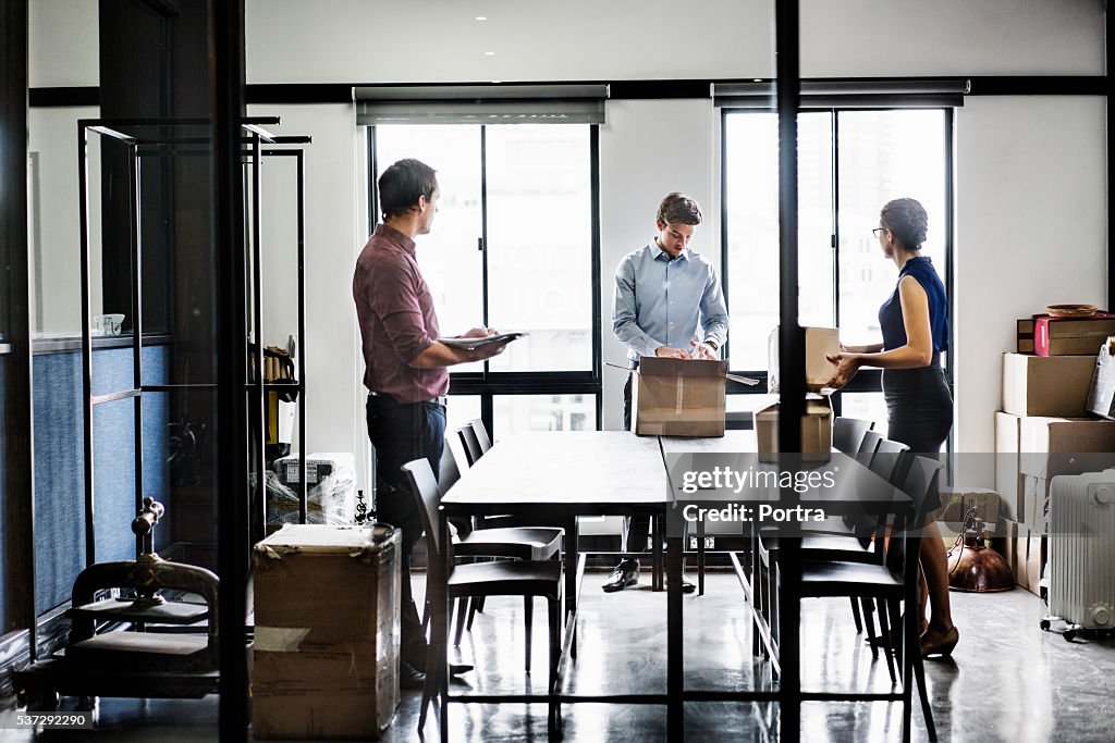 Business people with packing boxes in board room