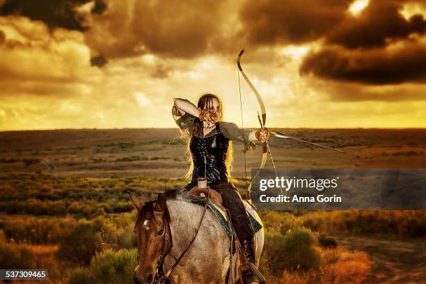 archer on horseback in medieval garb at sunset - 弓 ストックフォトと画像