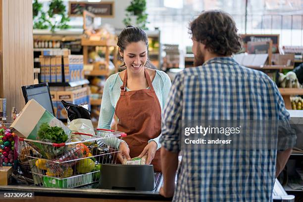 man grocery shopping at the supermarket - happy cashier stock pictures, royalty-free photos & images