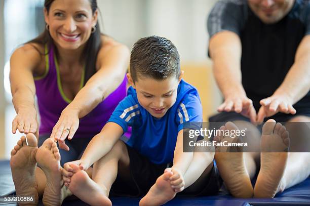 stretching to reach their toes - leisure facilities stock pictures, royalty-free photos & images