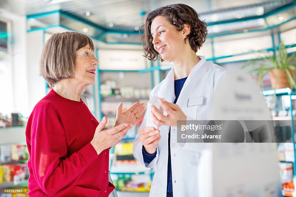 Senior woman consulting medicine dosage with the pharmacist