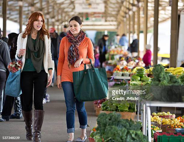 two friends shopping at a midwest farmers market. - agricultural fair stock pictures, royalty-free photos & images