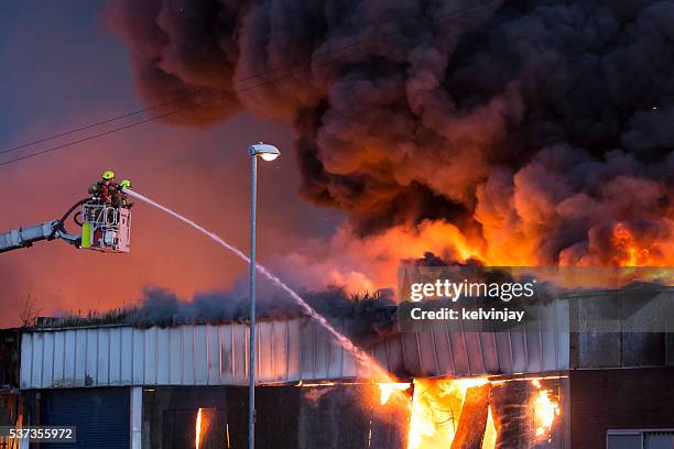 large fire at a warehouse in bramley, leeds - firefighter uk stock pictures, royalty-free photos & images