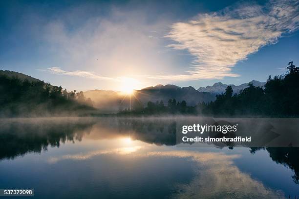 dawn at lake matheson - dawn clouds stock pictures, royalty-free photos & images