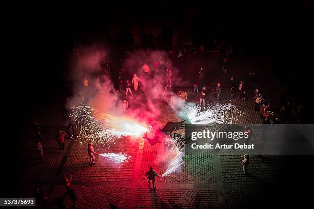 fire beasts correfoc at night from high angle view - correfoc stock pictures, royalty-free photos & images