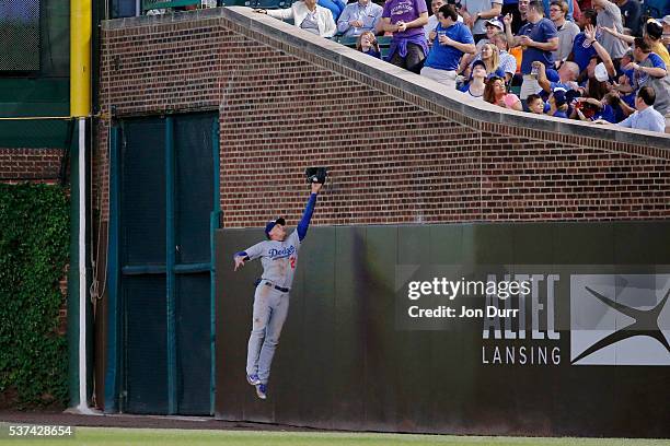 Trayce Thompson of the Los Angeles Dodgers makes a leaping catch for an out against the Chicago Cubs during the fourth inning at Wrigley Field on...