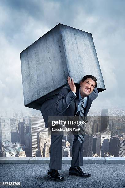 businessman struggling under weight of concrete block - carrying stock pictures, royalty-free photos & images