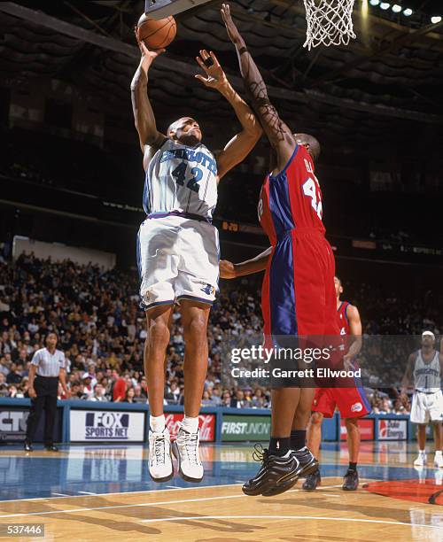 Forward P.J. Brown of the Charlotte Hornets shoots the ball over forward Elton Brand of the Los Angeles Clippers during the NBA game at the Charlotte...