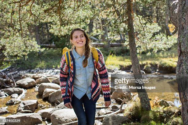 happy female hiker walking in forest - hiking woods stock pictures, royalty-free photos & images