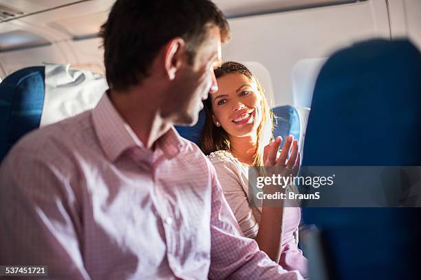 couple traveling by airplane. - couple airplane stockfoto's en -beelden