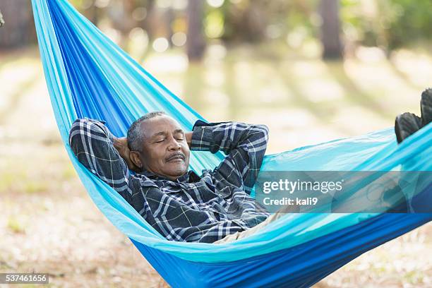 senior black man sleeping in a hammock - hammock camping stock pictures, royalty-free photos & images