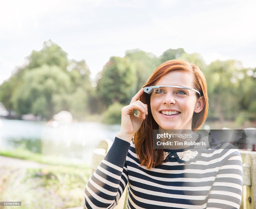 Young woman using smart glasses.