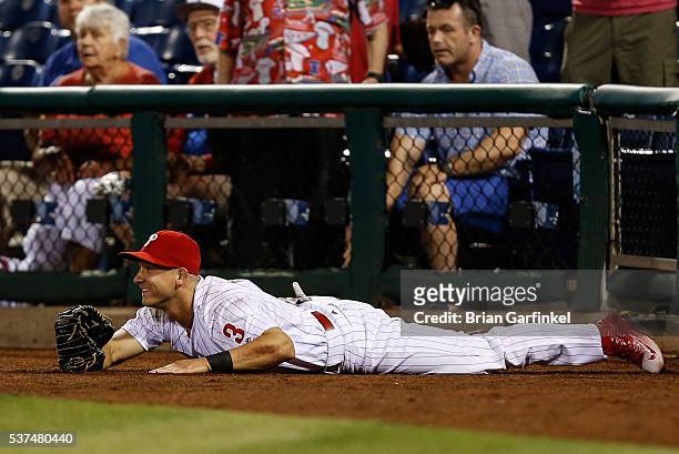 David Lough of the Philadelphia Phillies smiles after catching a foul ball hit by Jayson Werth of the Washington Nationals in the seventh inning of...