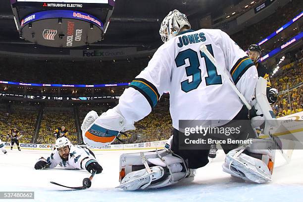 Roman Polak of the San Jose Sharks and Martin Jones attempt to block an assist by Nick Bonino of the Pittsburgh Penguins during the second period in...