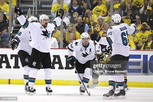 Justin Braun of the San Jose Sharks celebrates a third period goal with Logan Couture and Joonas Donskoi against the Pittsburgh Penguins in Game Two...