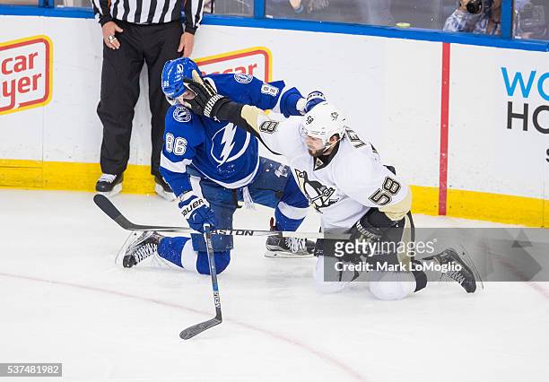 Kris Letang of the Pittsburgh Penguins pushes Nikita Kucherov of the Tampa Bay Lightning into a head lock during Game Four of the Eastern Conference...