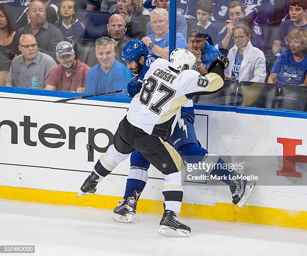 Jason Garrison of the Tampa Bay Lightning is checked by Sidney Crosby of the Pittsburgh Penguins during the third period of Game Four of the Eastern...