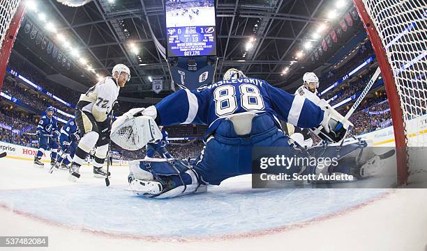 Goalie Andrei Vasilevskiy of the Tampa Bay Lightning stretches to make a save against Kris Letang of the Pittsburgh Penguins during the first period...