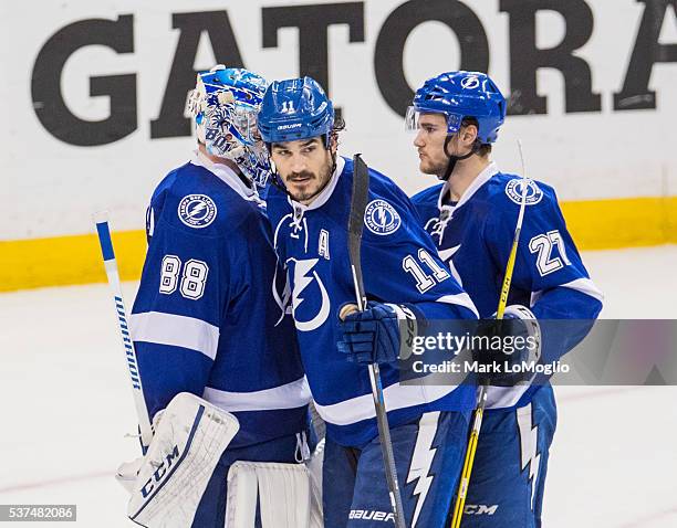 Brian Boyle, Jonathan Drouin, and goalie Andrei Vasilevskiy of the Tampa Bay Lightning celebrate the win against the Pittsburgh Penguins after Game...