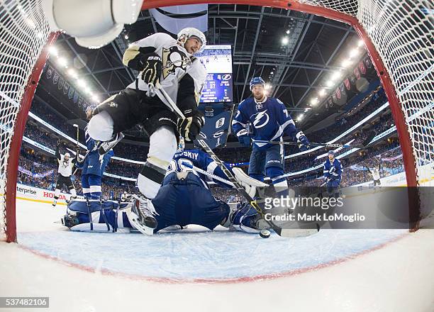 Chris Kunitz of the Pittsburgh Penguins leaps and reacts to a goal against goalie Andrei Vasilevskiy and the Tampa Bay Lightning during Game Four of...