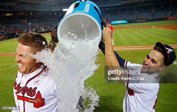 Freddie Freeman of the Atlanta Braves is dunked by Adonis Garcia and Ender Inciarte after his walk-off homer in their 5-4 win over the San Francisco...