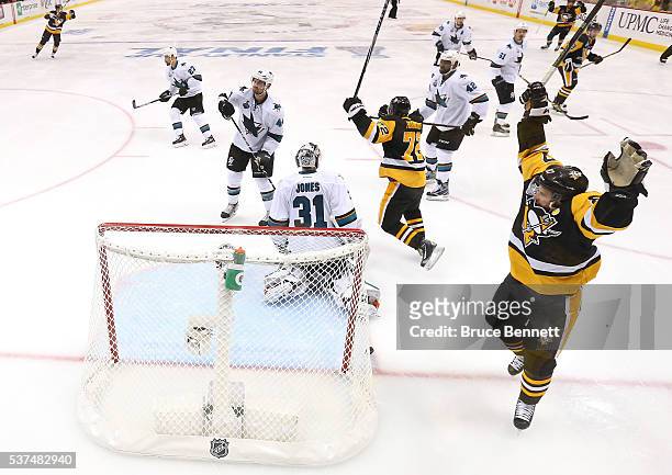 The Pittsburgh Penguins celebrate after Conor Sheary scored the game-winning goal against Martin Jones of the San Jose Sharks to win 2-1 in overtime...