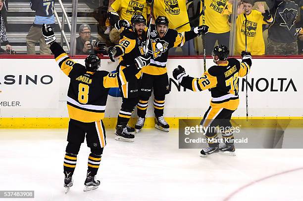 Conor Sheary of the Pittsburgh Penguins celebrates with teammates after scoring the game-winning goal to defeat the San Jose Sharks 2-1 during...