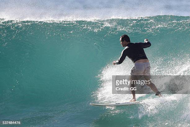 Former NRL player, Andrew Johns displays his surfing skills while on a beach outing with a female friend on May 24, 2016 in Sydney, Australia.