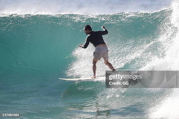 Former NRL player, Andrew Johns displays his surfing skills while on a beach outing with a female friend on May 24, 2016 in Sydney, Australia.