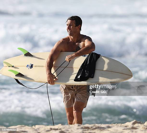 Former NRL player, Andrew Johns displays his surfing skills while on a beach outing with a female friend on May 24, 2016 in Sydney, Australia.