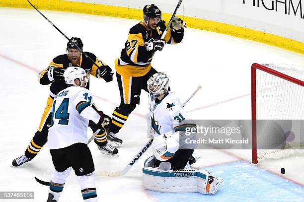 Patric Hornqvist of the Pittsburgh Penguins and Sidney Crosby celebrate after Conor Sheary scored the game-winning goal against Martin Jones of the...