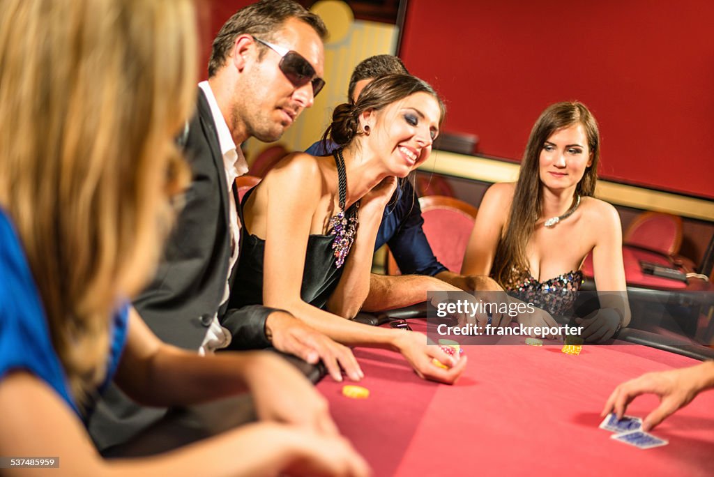 Friends playing at poker at Casino