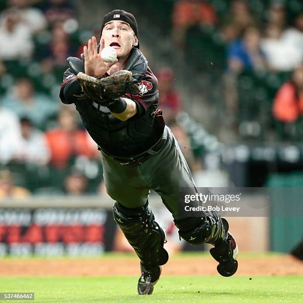 Chris Herrmann of the Arizona Diamondbacks makes a diving attempt on a bunt attempt by Marwin Gonzalez of the Houston Astros in the tenth inning at...