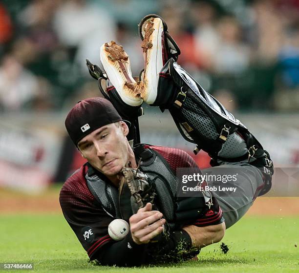 Chris Herrmann of the Arizona Diamondbacks makes a diving attempt on a bunt attempt by Marwin Gonzalez of the Houston Astros in the tenth inning at...