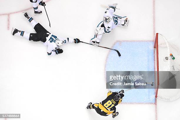Phil Kessel of the Pittsburgh Penguins scores a second period goal against Martin Jones of the San Jose Sharks as Roman Polak attempts to defend in...
