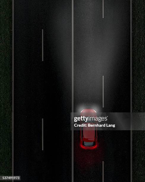 red car on street by night, aerial view - road marking stock pictures, royalty-free photos & images