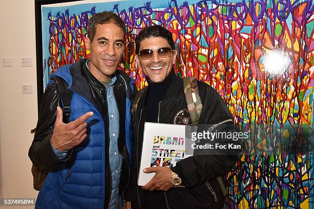 Actor Said Taghmaoui and street painter JoOne pose with a work of JoOne during the Street Art Exhibition Preview in Galerie Laurent Strouk as part of...