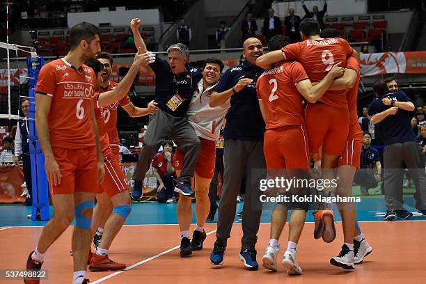 Head coach of Iran Raul Lozano of Iran celebrates with his players after winning the Men's World Olympic Qualification game between Iran and China at...