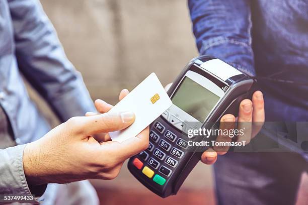 contactless payment - handing over credit card stock pictures, royalty-free photos & images