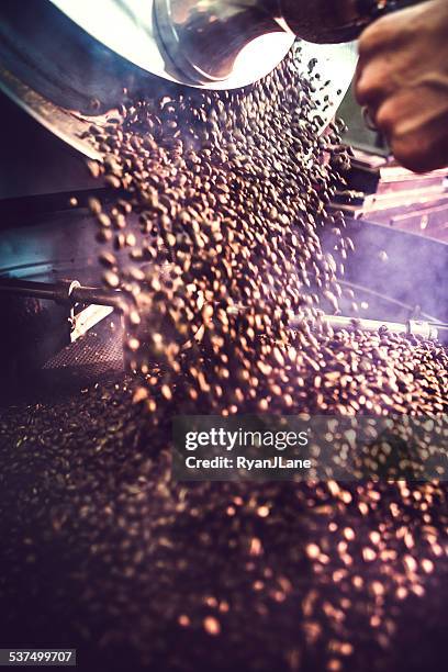coffee roaster in action - coffee manufacturing stock pictures, royalty-free photos & images
