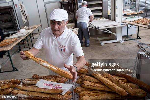 An illustrative picture showing the making of french baguettes in a bakery during the annual Bread Fair on May 21, 2016 in Paris, France.