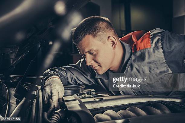 professional car mechanic working in auto repair service - diagnostic aid stock pictures, royalty-free photos & images